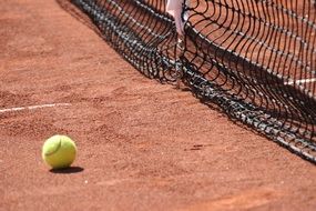 tennis ball on the court near the net