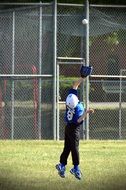 athlete catching a ball with a baseball glove