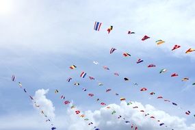 many different flags against the sky