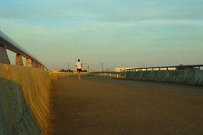 man running along the boardwalk