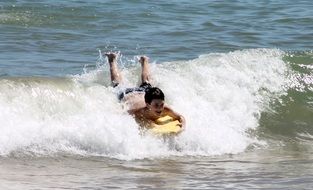 child riding a Board on the waves