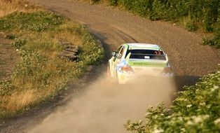 rallycross, mitsubishi car speeding on soil road