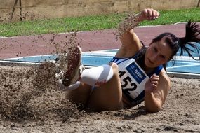 athlete jumping on the sand