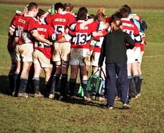 hugging rugby team on a field