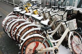 bicycles in the parking lot in the snow