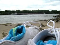 sports shoes on the beach