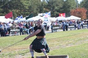 power throw in traditional Scottish clothing