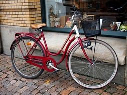 vintage women’s bike on pavement at shop display