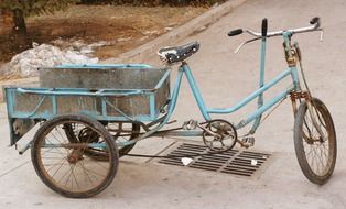 old weathered cargo bike on pavement