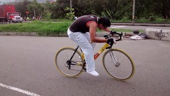 man riding sports bicycle on road