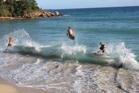 surfers jump on the wave