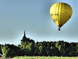 yellow balloon over a green meadow