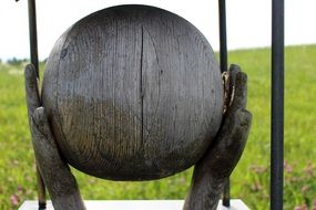 wooden ball symbol in hands