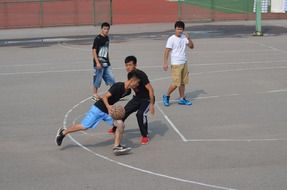 basketball players on a street playground