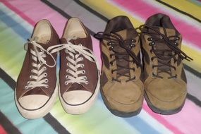 two pairs of sports shoes on colorful carpet