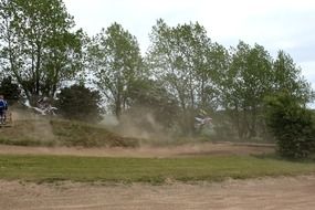 motocross racing on soil road in dust