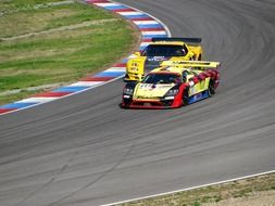 race car overtakes race car on the track