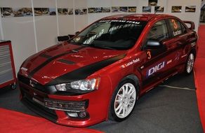 red Mitsubishi racing in a auto show