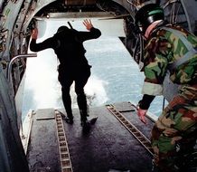 the military is preparing to jump from a helicopter