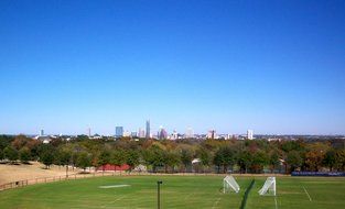 soccer field in front of city skyline, usa, texas, austin