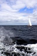 white sailing boat in the dark sea