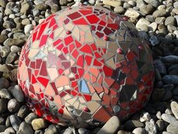 colored ceramic ball on pebbles