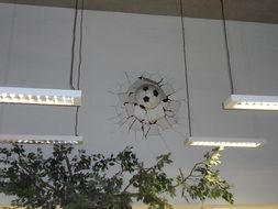 Football ball in the broken wall