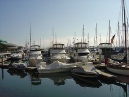 boats and yacht on calm water at pier