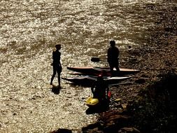 kayakers on the beach in the sunset