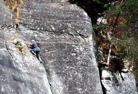 young man climbing rock