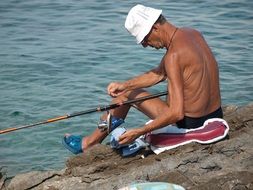 old fisherman in white hat