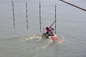 the athlete is swimming in a canoe with a paddle