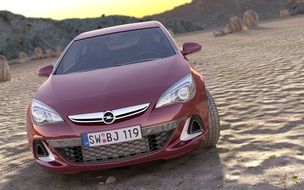 Red Opel automobile on the sand