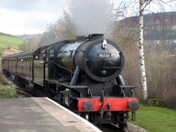 steam train on the railway at the station