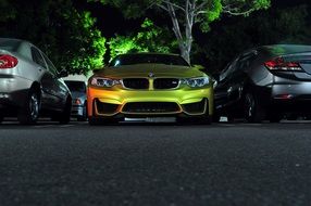 yellow bmw car on parking at night