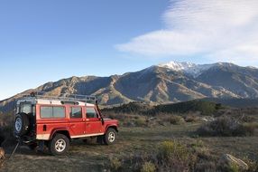 red Land Rover in Pyrenees landscape