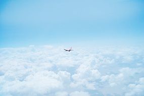 a plane in the sky above the clouds