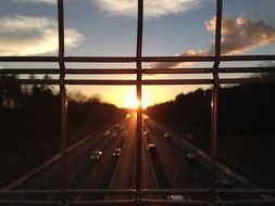 highway traffic panorama through the bars