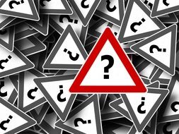 many road signs with question marks