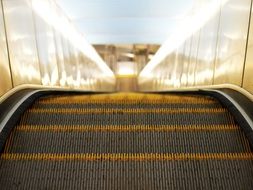 moving down escalator steps