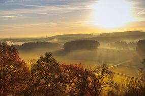 gold sunrise above meadow landscape