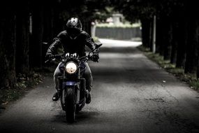 biker rides a motorcycle on the road