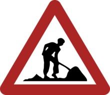 road sign with a image of a builder