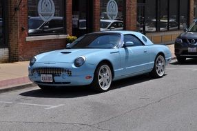 blue retro car on city street