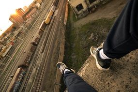 man in sports shoes over the railway