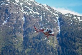 helicopter in the mountains in Alaska