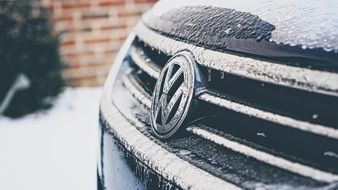 Volkswagen badge on a snowy car