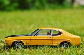 yellow car on green grass