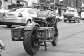 black and white photo of a retro motorcycle on the street