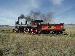 blue smoke locomotive on rail